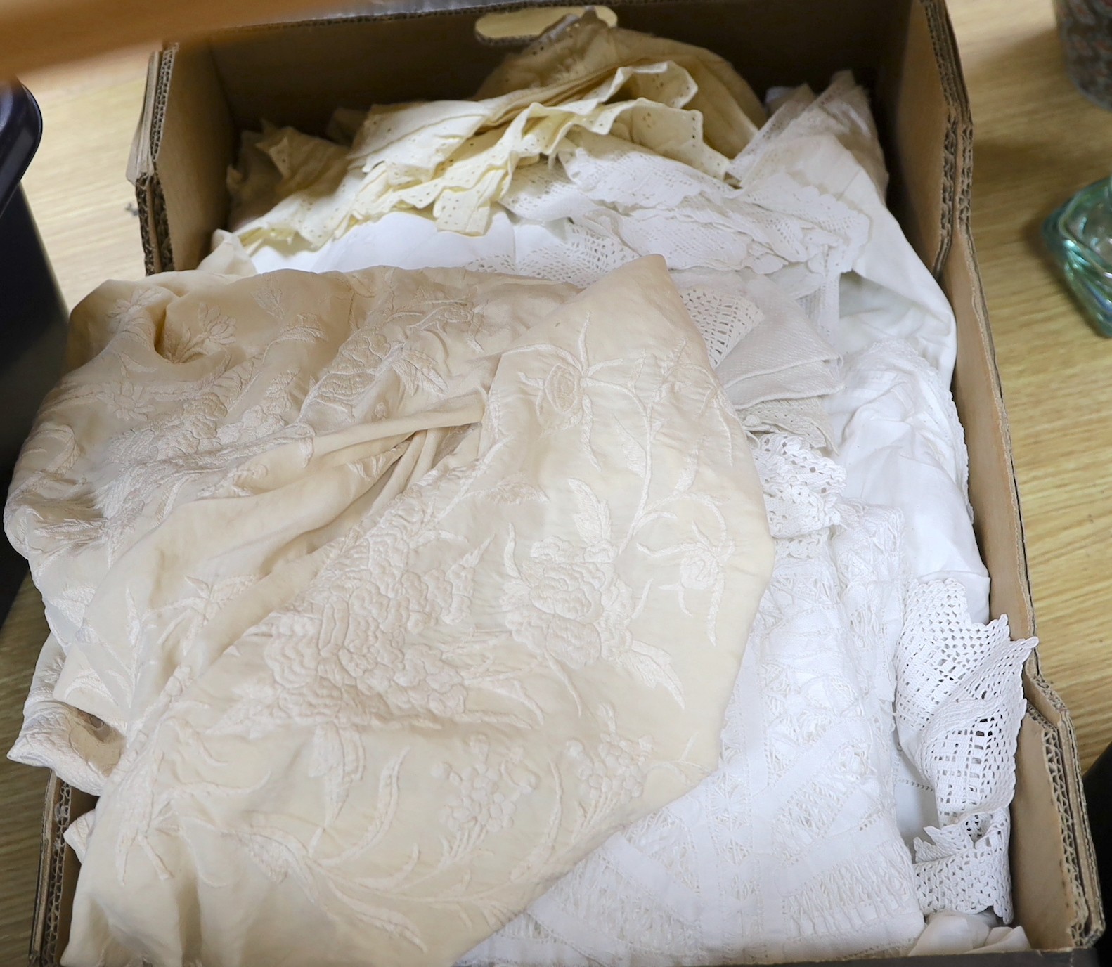 A late 19th century Chinese cream silk embroidered shawl, a tape lace bed cover and a collection of smaller cloths with crochet edges